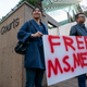 Supporters of Meng Wanzhou stand with a sign outside the British Columbia Supreme Court on December 10, 2018
